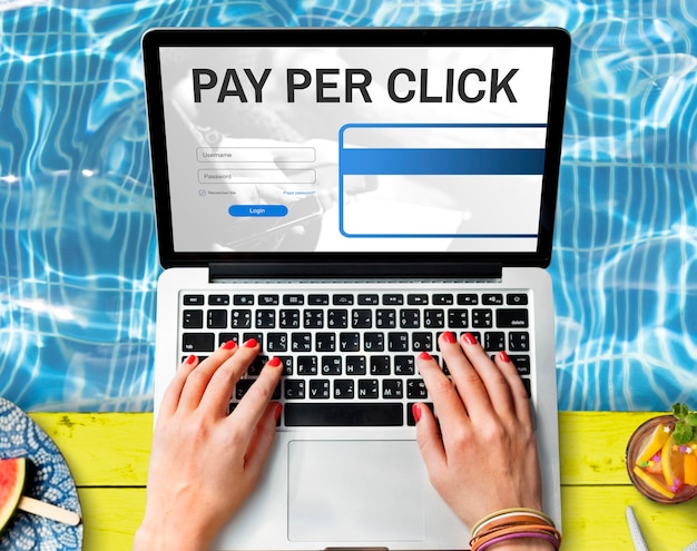 profile Qwen3-235B-A22B 12:21 pm A laptop displaying "PAY PER CLICK" with login fields, placed on a vibrant yellow surface near a pool, surrounded by refreshing summer elements like watermelon and fruit skewers.